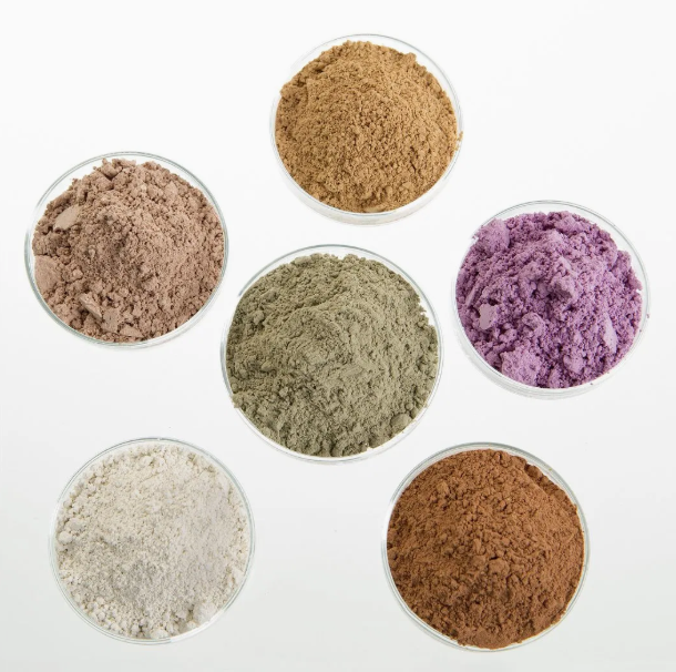 Grey bentonite clay powder in industrial bags, absorbent mineral used in drilling fluids
