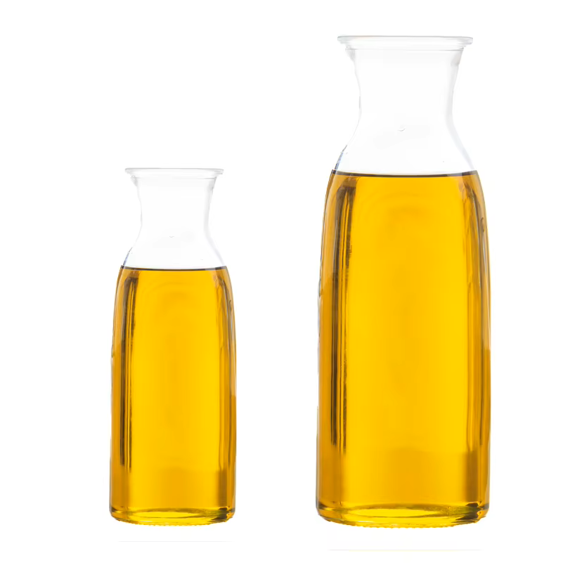 Light golden base oil SN150 flowing from industrial drum into container