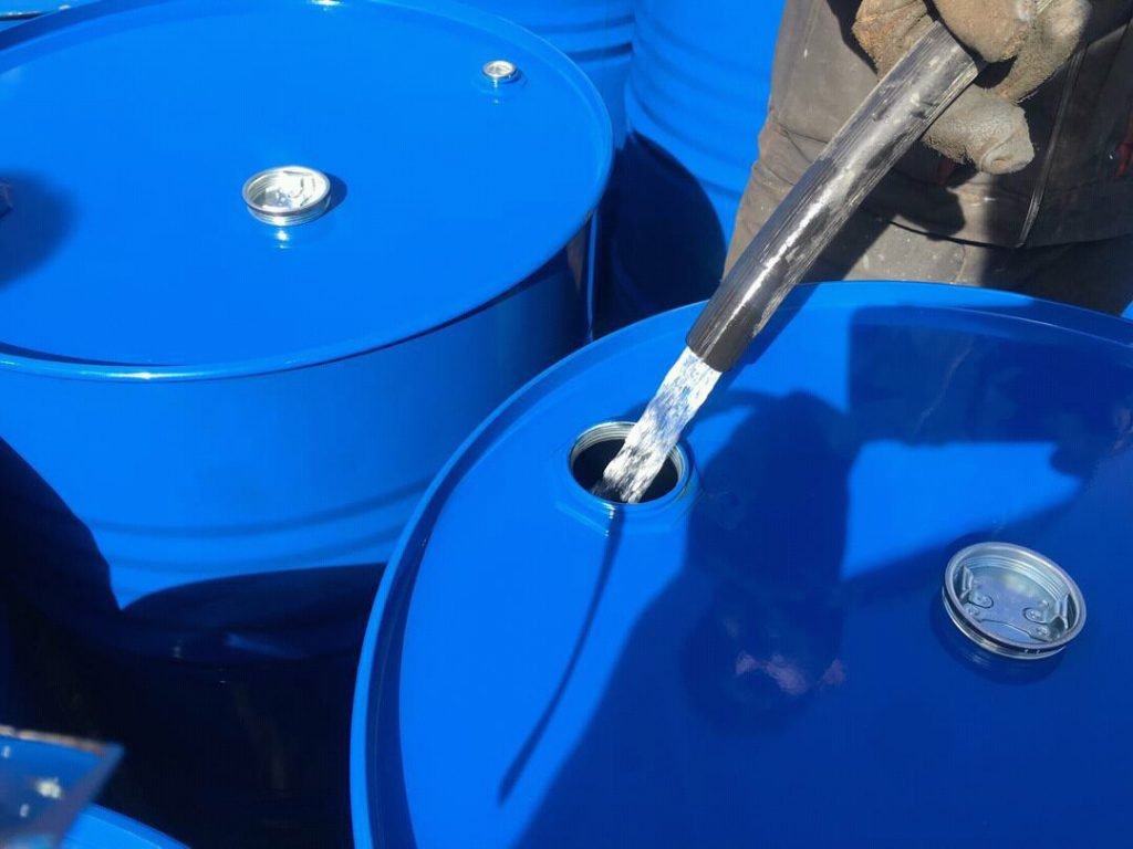 White spirit solvent in clear container, used for paint thinning and cleaning
